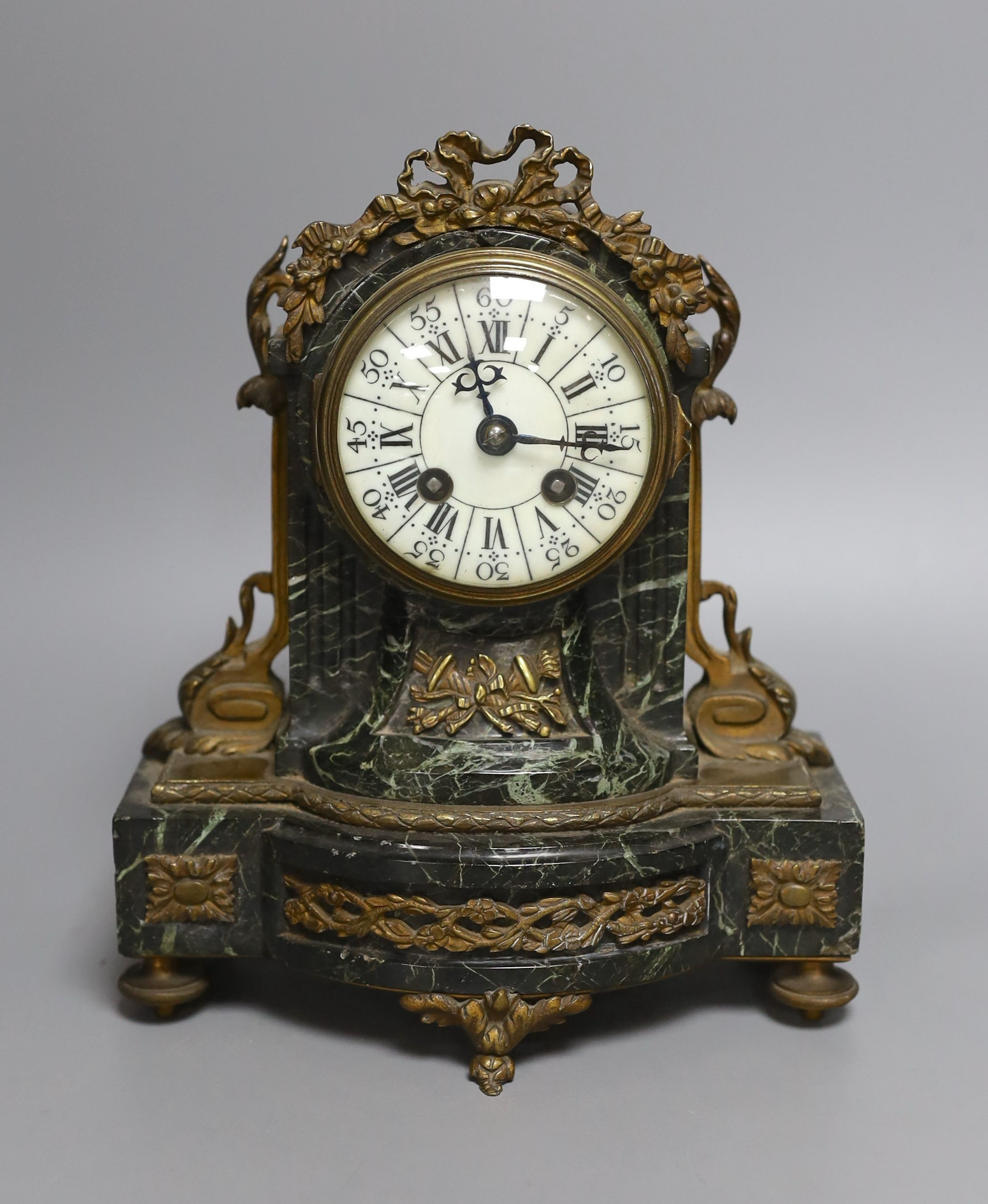 A 19th century French gilt metal mounted serpentine mantel clock, 23cms high.